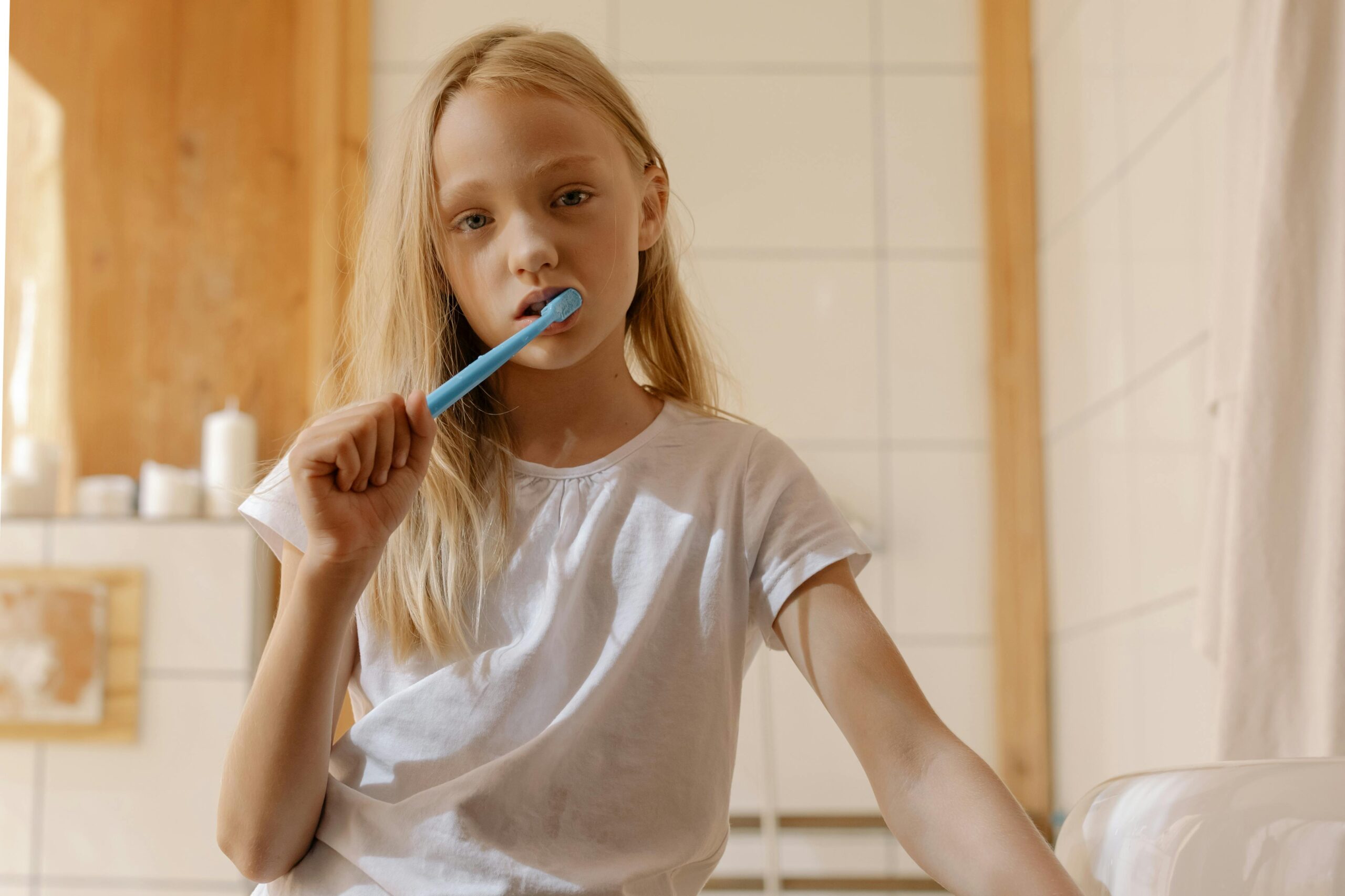 Person brushing teeth with toothpaste — choosing the right toothpaste, Langley dentist