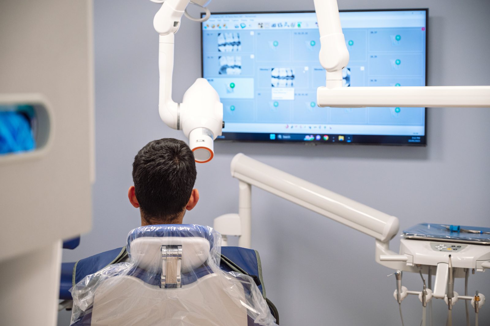 Patient relaxing in a dental chair in a treatment room at iSmile Dental in Langley, BC